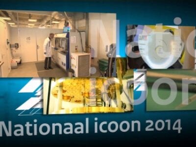 Nationaal Icoon 2014. We zien een blauwe achtergrond met een viertal foto's. Eén is scherp: een laboratorium. Onder staat de tekst: Nationaal Icoon 2014.